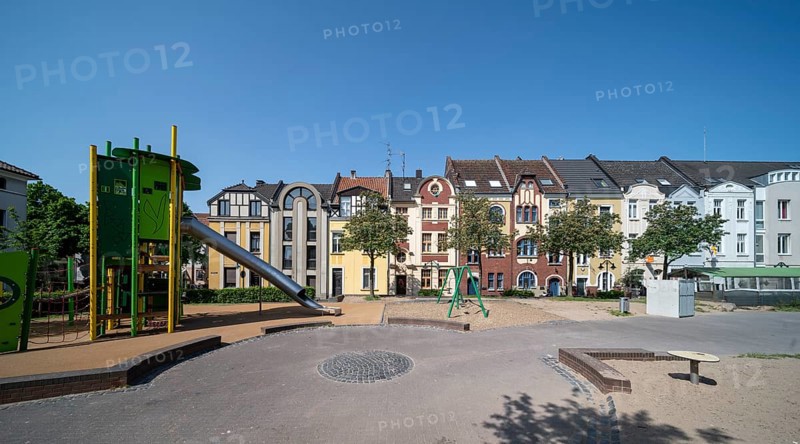 Krefeld, row of houses and playground at Anne-Frank-Platz
