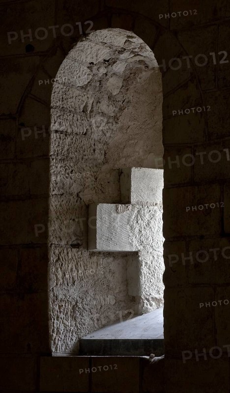 Saint-Aignan, collegiate church, crypt. Porch, window niche with cross. The present church of Saint-Aignan was built between the beginning of the 11th and the beginning of the 13th century on the site of a 9th century chapel. The chapel had received relics of St Anianus, Bishop of Orléans, and had become a much-visited pilgrimage site. The church originally had a foundation, St., Saint, Saint