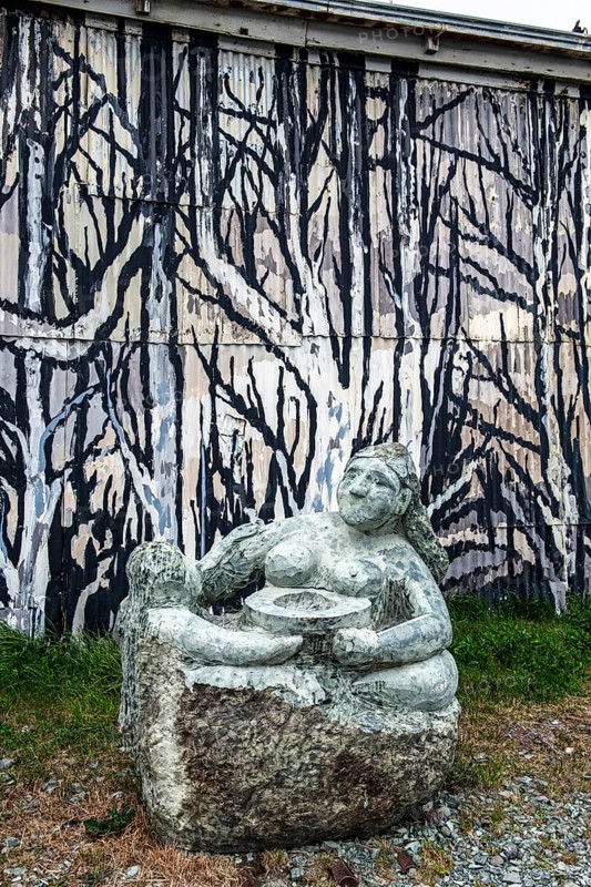 Statue and mural depicting the cultural heritage of the Aonikenk and Kaweshar ethnic groups, Puerto Natales, Patagonia, Chile, South America