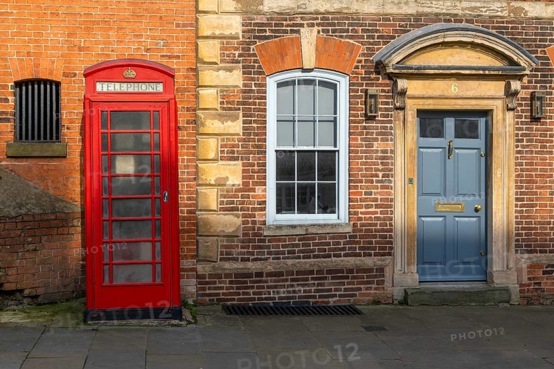 Traditional K6 red phone box and historic Houston Castle Hill, city of Lincoln, Lincolnshire, England, UK