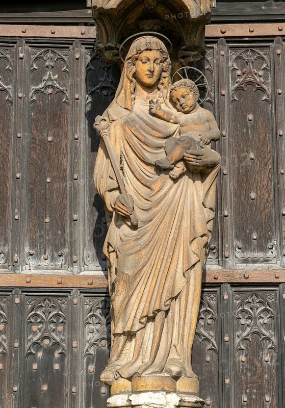 Statue of Mary and baby Jesus in doorway, Cathedral Church of the Blessed Virgin Mary, Lincoln, Lincolnshire, England, UK