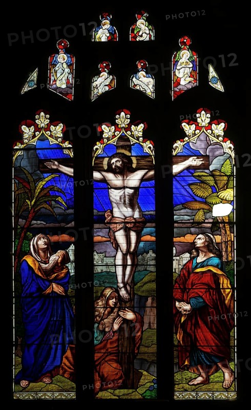Stained glass window of Jesus Christ Crucifixion Cross, church of Saint John the Baptist, Devizes, Wiltshire, England, UK by Reverend Alfred Charles Smith 1881