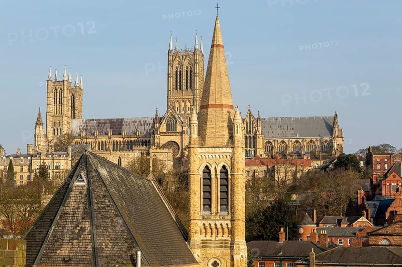 Church of Saint Hugh in foreground with towers of cathedral behind, Lincoln, Lincolnshire, England, UK
