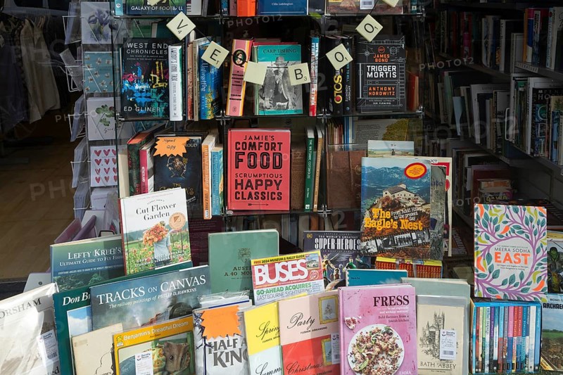 Shop window display of secondhand books in Dorothy House charity shop, Chippenham, Wiltshire, England, UK