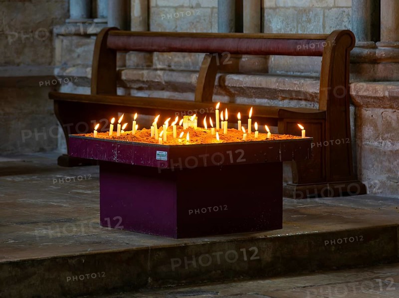 Lit candles burning inside cathedral, city of Lincoln, Lincolnshire, England, UK