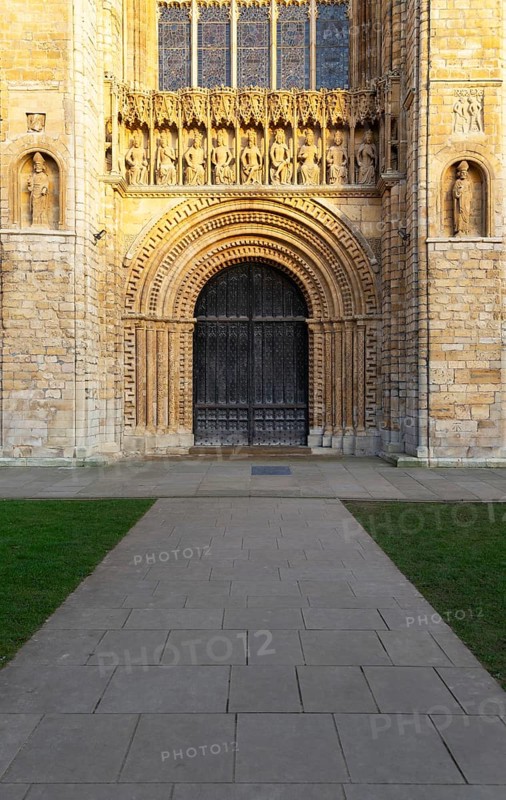 Carved stonework figures of kings, Gallery of Kings above doorway, frontage of cathedral church, Lincoln, Lincolnshire, England, UK