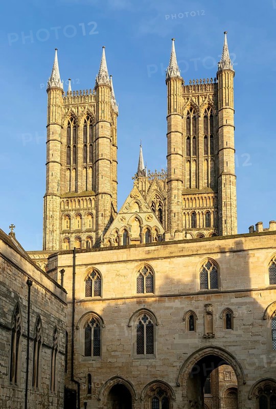Towers of cathedral church rise above the medieval Exchequer Gate, Lincoln, Lincolnshire, England, UK