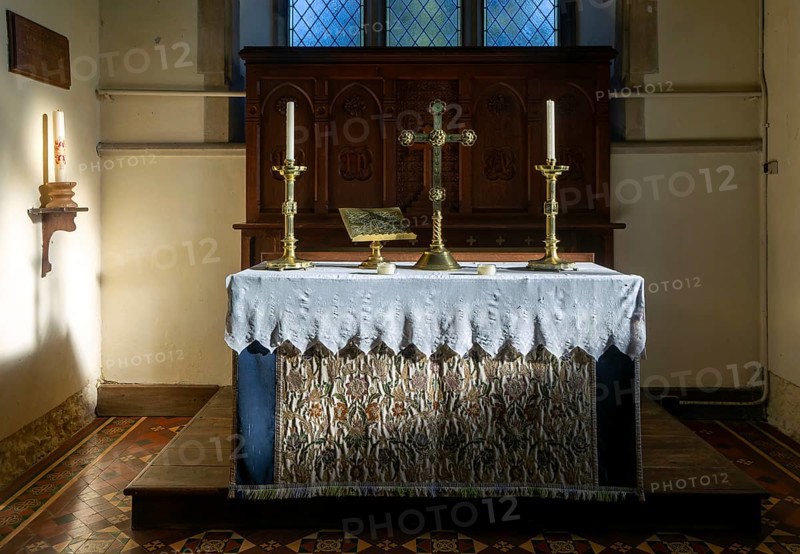 Altar with candles and cross inside parish church of Saint Mary, Walpole, Suffolk, England, UK