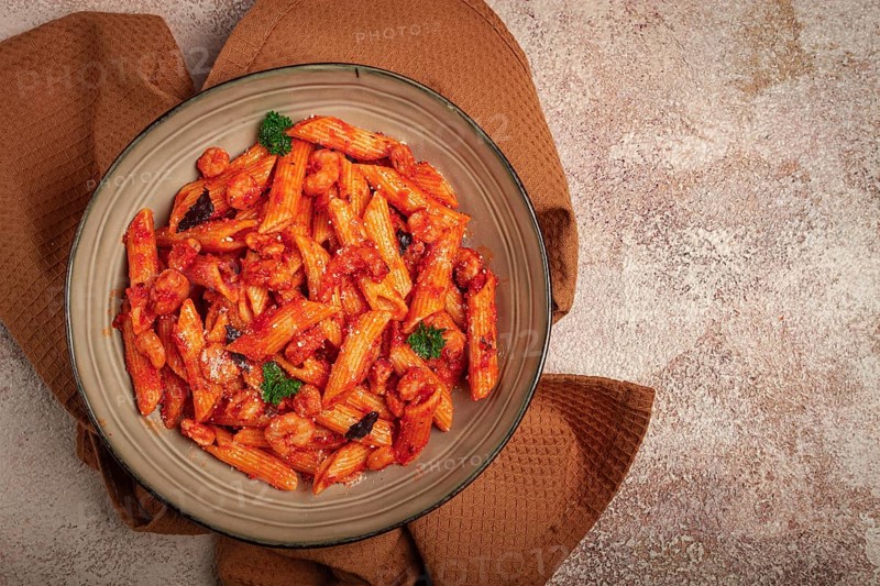 Penne pasta, with shrimp in tomato sauce, close-up, no people