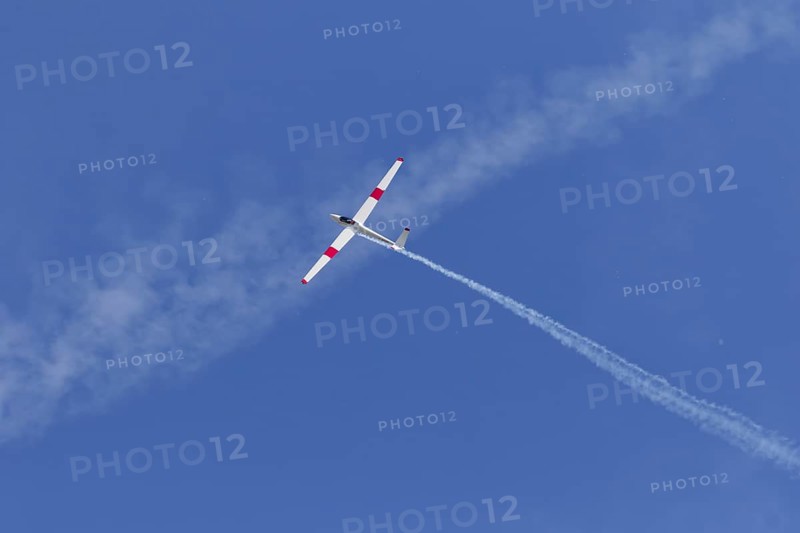 Airshow, glider with contrails against blue sky, Montreal, Province of Quebec, Canada, North America