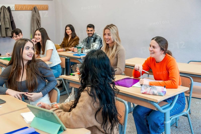 Cheerful university students are actively participating in a class, engaging in discussions and collaborating on their studies at their institute