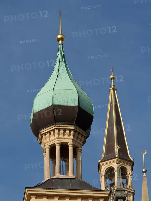 Two architecturally decorated towers with green copper roofs against a blue sky, Schwerin, Germany, Europe