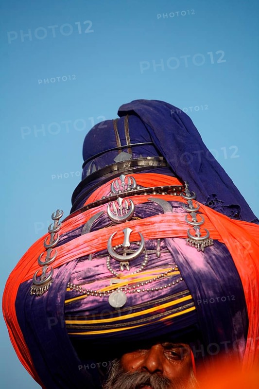 Nihang or Sikh warrior in pagdi or headgear with sword during Hola Mohalla festival at Anandpur sahib in Rupnagar