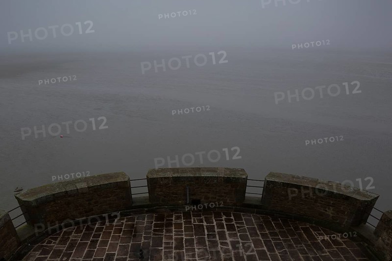 Mont-Saint-Michel, monastery mountain, view from the Tour Cholet into the mudflats in foggy weather