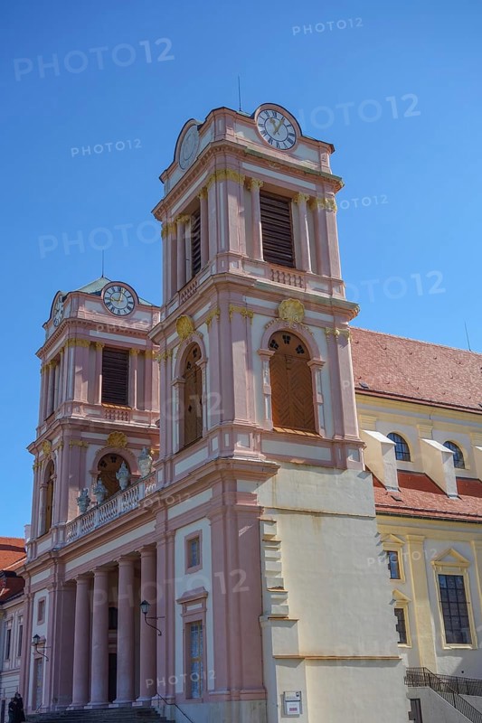 Baroque church with striking pink towers and blue sky, wachaus, donau, austria