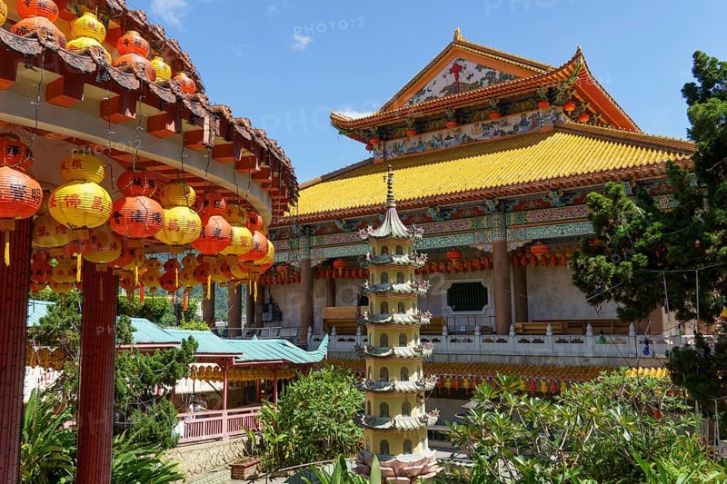 View of a temple complex with a pagoda and colourful lanterns. Embedded in lush nature, penang, malaysia