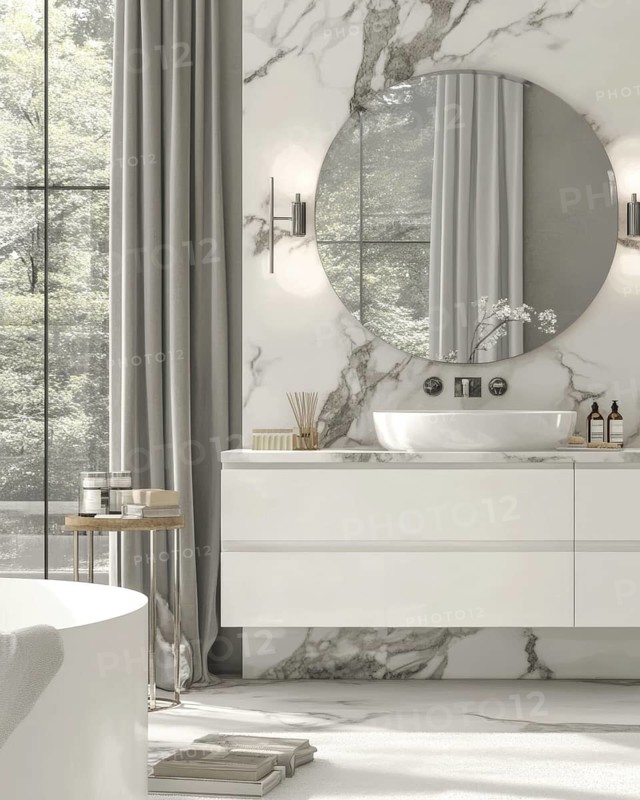 A contemporary bathroom bathed in natural light, showcasing marble walls, a round mirror, and a white vanity. The minimalist design is complemented by a bathtub and an exterior view, AI generated