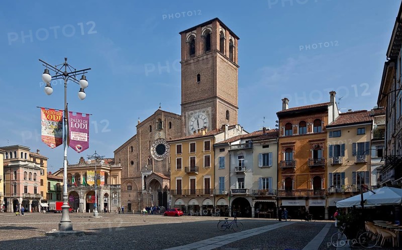 Italy Lodi 89763 Piazza della Vittoria surrounded by arcaded houses of the 15-17th century north-east square front with S Bassiano cathedral 1163-1284 tower rebuilt in the 16th century