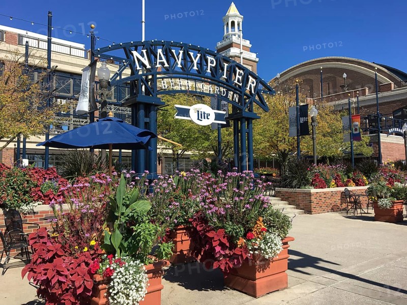 Colourful flowers and Navy Pier sign in sunny weather create a lively atmosphere, chicago, illinois, usa