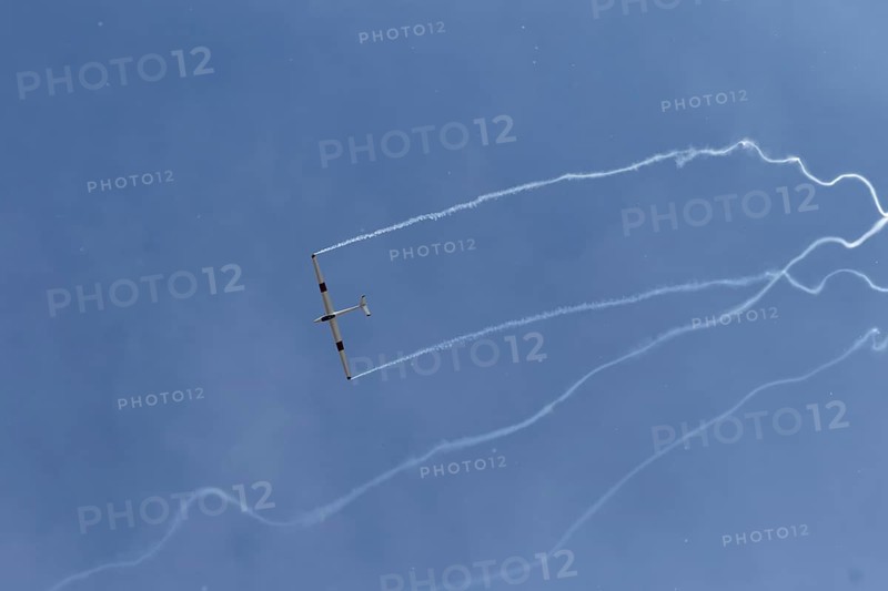 Airshow, glider with contrails against blue sky, Montreal, Province of Quebec, Canada, North America