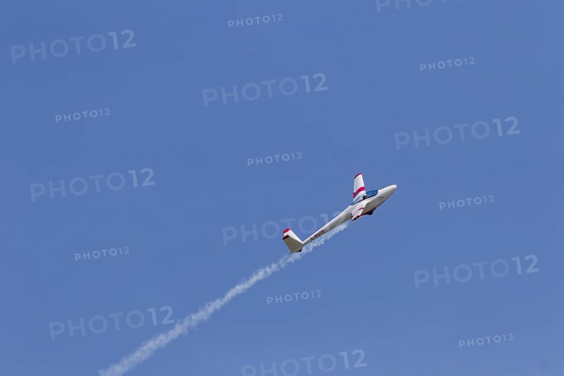 Airshow, glider with contrails against blue sky, Montreal, Province of Quebec, Canada, North America
