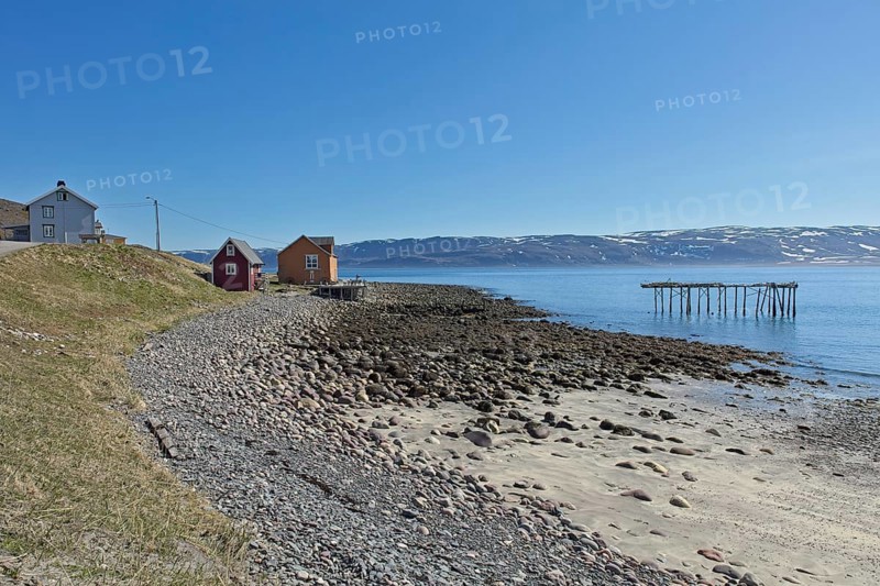 Buildings at seashore at Veidnes on a clear summer day, Kongsfjord, Norway, Europe