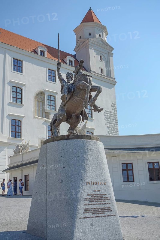 Majestic equestrian statue in front of a historic castle building under a clear sky, bratislava, danube, slovakia
