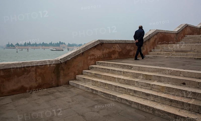 Italy Venice Fondamenta Nove -383 Bridge stairs in the course of the Fondamenta Nove with a pedestrian in the background the cemetery island of San Michele