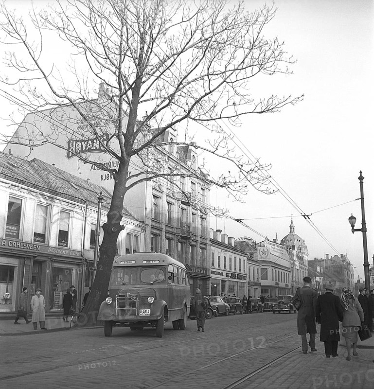 Trondheim Norway 1949. A busy street in the city with people walking and a bus leaving the bus stop. Kristoffersson ref AU42-7