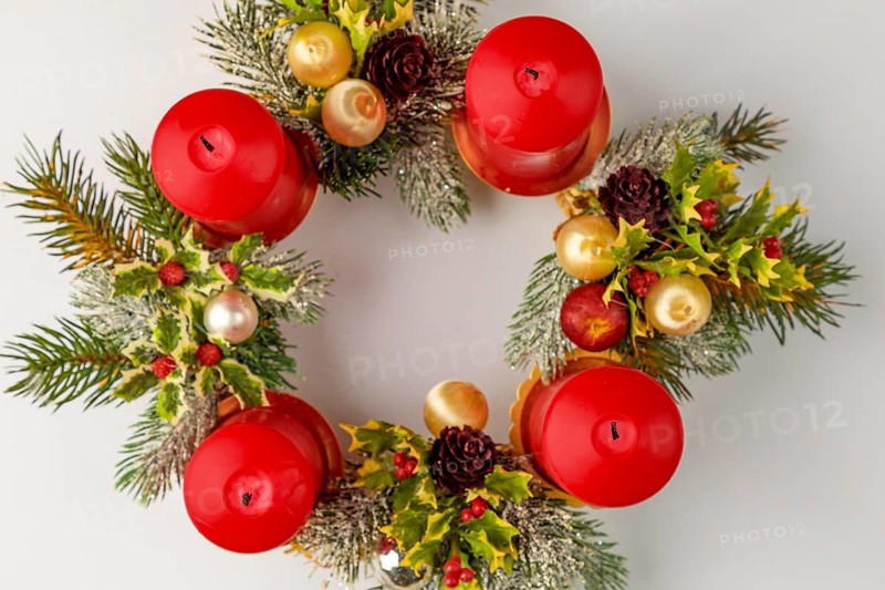 Round Advent wreath with red candles and Christmas decorations, from above