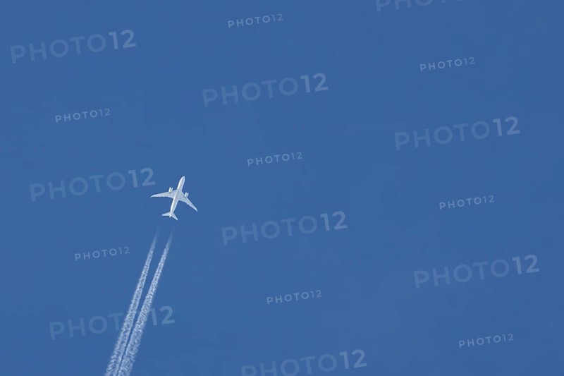 Boeing 787-8 Dreamliner jet passenger aircraft of Aeromexico flying in a blue sky with a vapor trail or contrail behind, England, United Kingdom, Europe