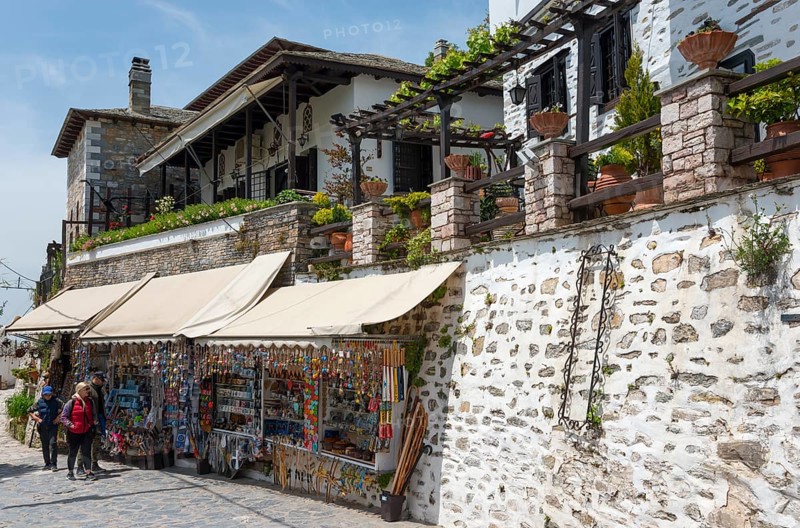 Street with souvenir shops and traditional houses, tourists looking at displays, sunny day, Makrinitsa, balcony of Pilio, Municipality of Volos, Pilio Mountains, Thessaly, Greece, Europe