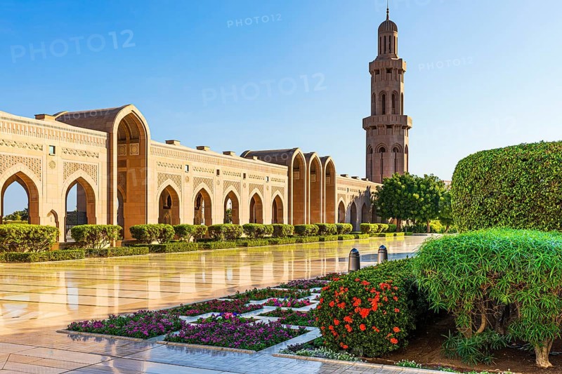 Side wing with minaret and flower-decorated courtyard of the Sultan Qaboos Mosque, Muscat, Arabian Peninsula, Sultanate of Oman