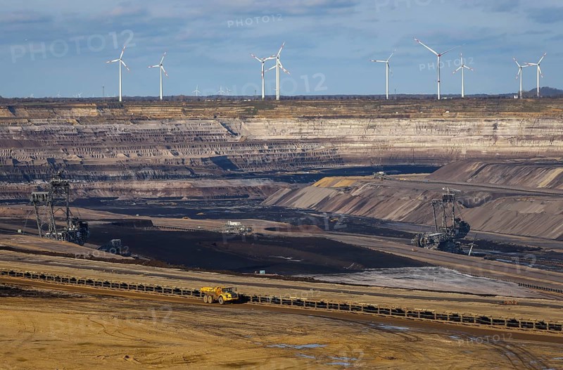 Erkelenz, North Rhine-Westphalia, Germany, Rhenish lignite mining area, bucket wheel excavator in RWE's Garzweiler opencast lignite mine, here near Lützerath. Wind turbines in the back, Europe