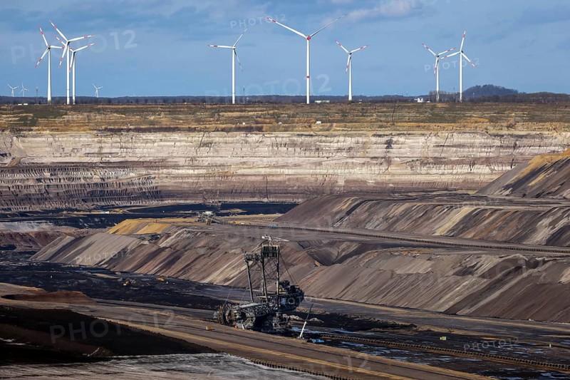 Erkelenz, North Rhine-Westphalia, Germany, Rhenish lignite mining area, bucket wheel excavator in RWE's Garzweiler opencast lignite mine, here near Lützerath. Wind turbines in the back, Europe