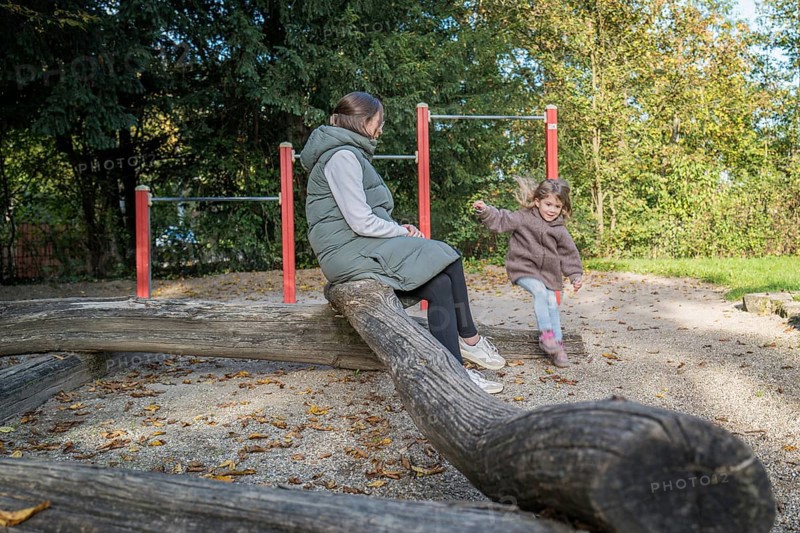 Mother with frolicking child on an autumn playground, Stuttgart, Baden-Württemberg, Germany, Europe