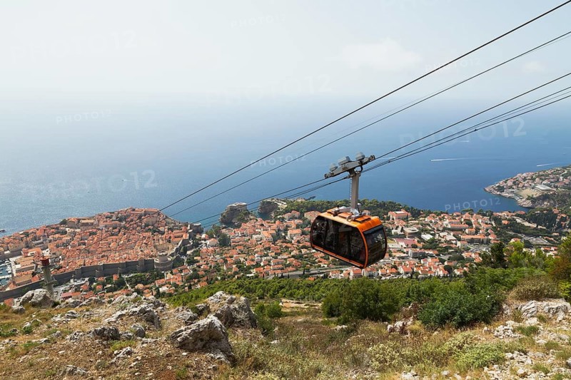 High angle view of cable car transporting tourists from top of Mount Srd down to Dubrovnik city center in late summer, Croatia, Europe