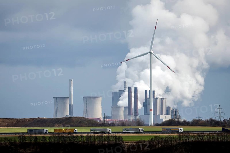 Grevenbroich, North Rhine-Westphalia, Germany - Lorry on A44 motorway and wind farm in front of RWE Neurath power station, lignite-fired power station at RWE's Garzweiler opencast lignite mine