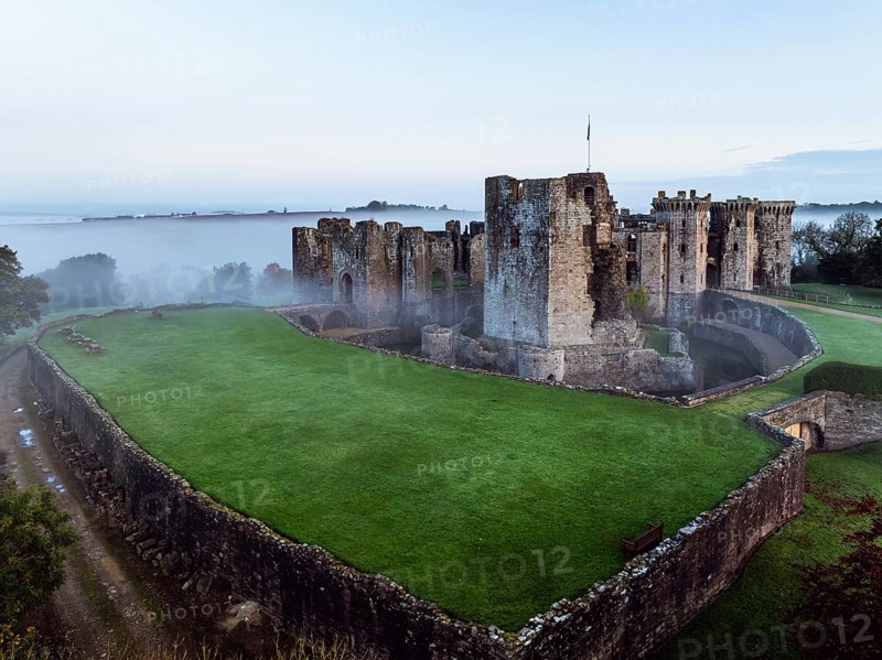 Raglan Castle in the fog at dawn from a drone, Monmouthshire, Wales, England, United Kingdom, Europe