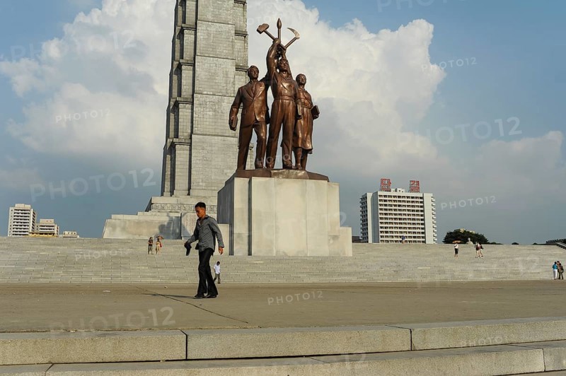 08.08.2012, Pyongyang, North Korea, Asia, A man passes in front of the Juche Monument on the banks of the Taedong River, Asia