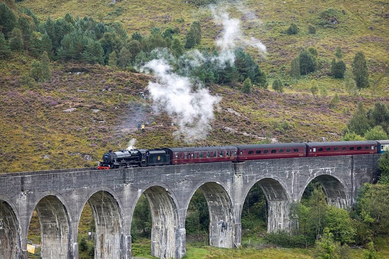 The Jacobite Steam Train, steam railway on the Glenfinnan railway viaduct, known from Harry Potter, Glenfinnan, Highlands, Scotland, Great Britain