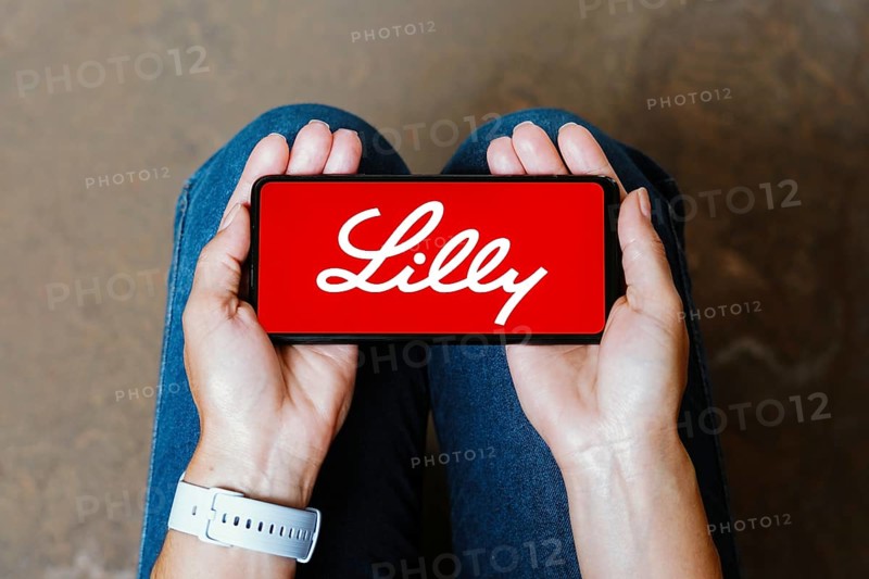 In this photo illustration, the Eli Lilly logo is displayed on a smartphone screen