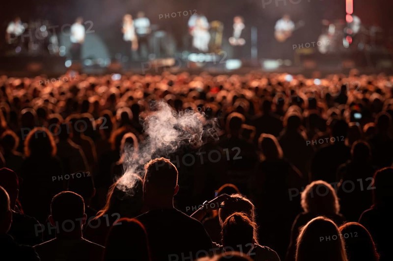 Crowd of people in front of the stage during the concert.