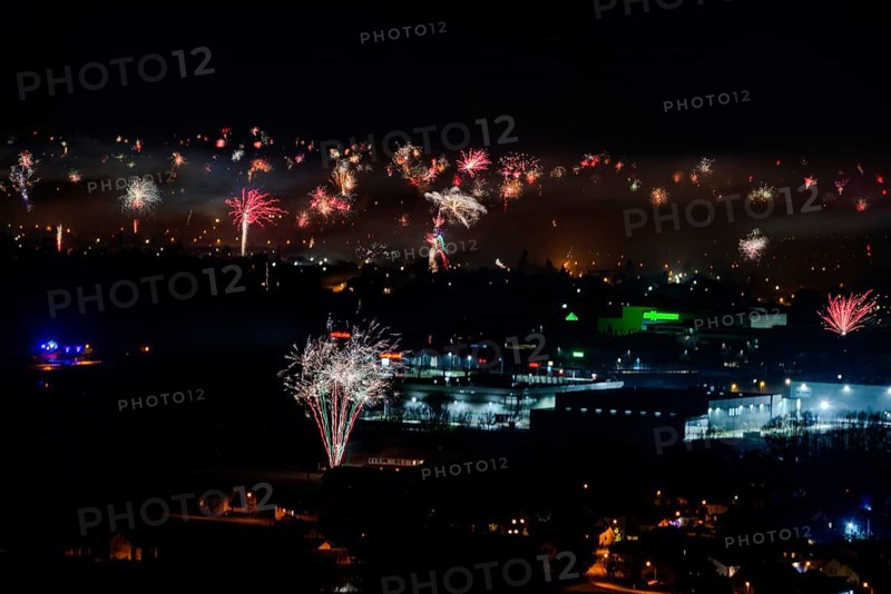 Large firework explosions light up the evening scenery of the city, Straubing, Lower Bavaria