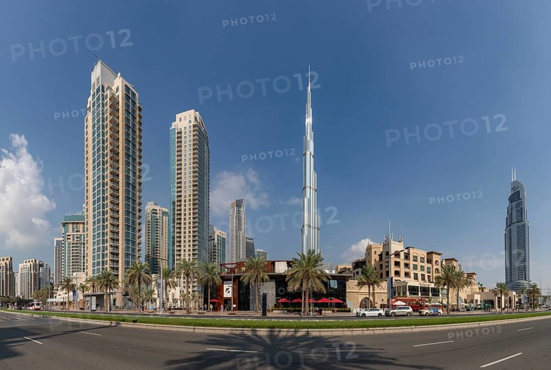 A picture of the Burj Khalifa towering nearby Downtown Dubai buildings