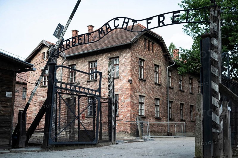 The main gate to the concentration camp Auschwitz Birkenau with an inscription in German Arbeit Macht Frei (work makes free)