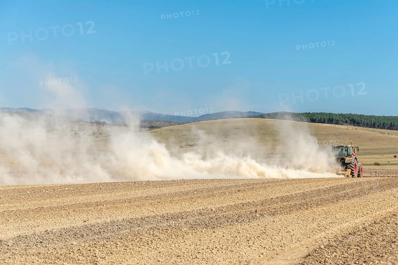 Dust cloud lifted by tractor in times of drought. Cevennes, massif central, France, Europe