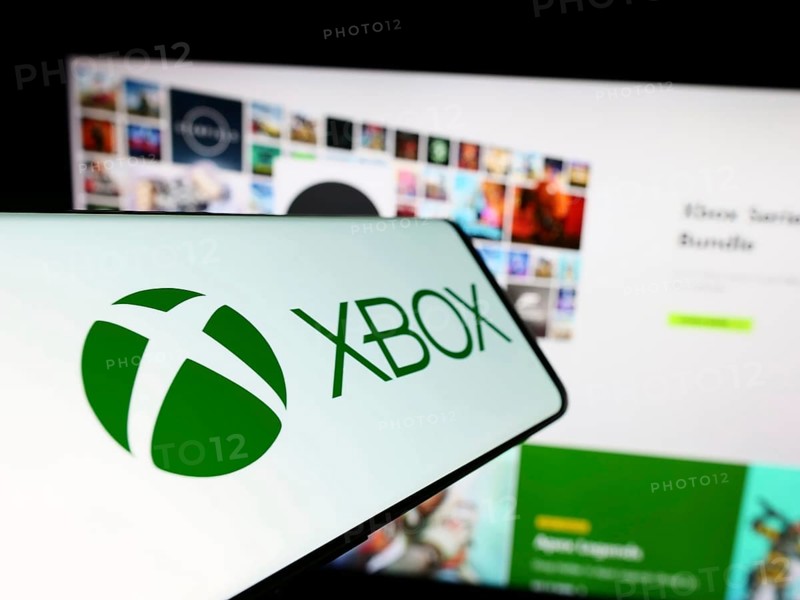 Stuttgart, Germany, 02-14-2024: Mobile phone with logo of video game console Xbox (Microsoft) in front of business website. Focus on center-left of phone display, Europe