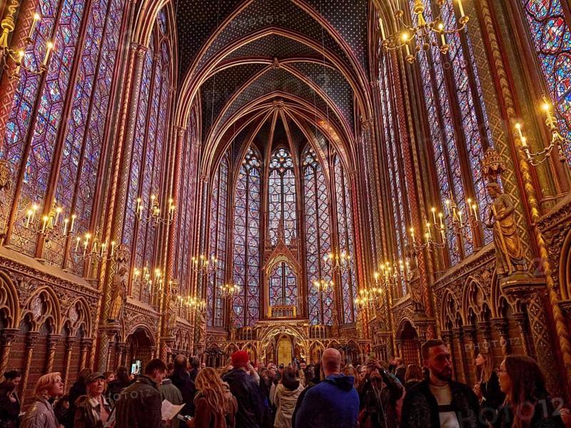A lively church interior with Gothic architecture and magnificent stained-glass windows, Sainte-Chapelle. Paris