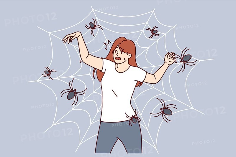 Woman with fear of spiders is terrified of being entangled in cobweb and needs treatment for arachnophobia. Girl with arachnophobia screams in fear imagining that she has become victim of insects